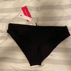 Black hipster bikini bottoms with side cutouts